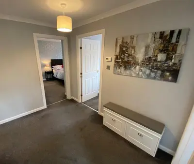 a room with a bed and a painting on the wall at NEW Super 2 Bedroom Flat in Falkirk in Falkirk