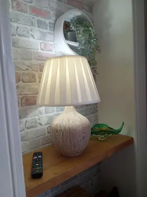 a lamp sitting on a table with a remote control at On Yer Bike & Gone Fishin in Millport