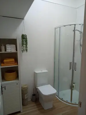 a bathroom with a toilet and a glass shower at On Yer Bike & Gone Fishin in Millport