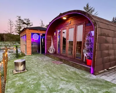 a small house with an archway in a yard at FINN VILLAGE - Loch Lomond Sunset Glamping Pod - Private Ofuro HOT TUB in Drymen