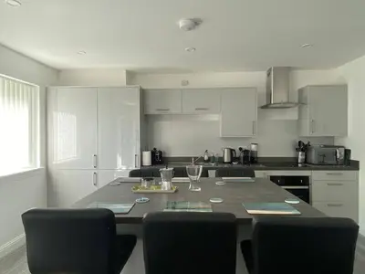 a kitchen with a large table with chairs in it at Beautiful Riverside Holiday Home in Callander