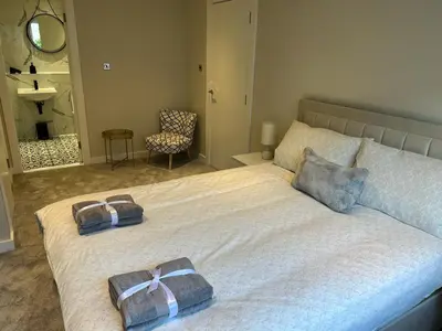 a bedroom with a bed with two pillows on it at Strada Apartment in Edinburgh