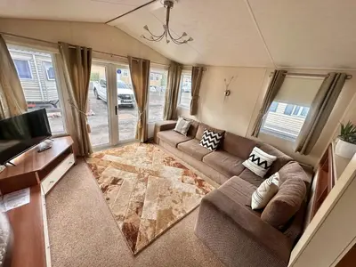 a living room with a couch and a tv at 2-Bedroom Caravan Located in Uddingston, Glasgow at Maryville Caravan Site in Uddingston