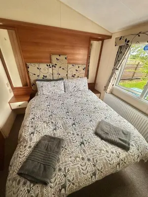 a bedroom with a bed with two pillows on it at 2-Bedroom Caravan Located in Uddingston, Glasgow at Maryville Caravan Site in Uddingston