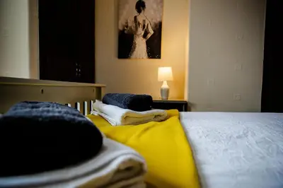 a bedroom with two beds with towels on them at Rigside House in Douglas