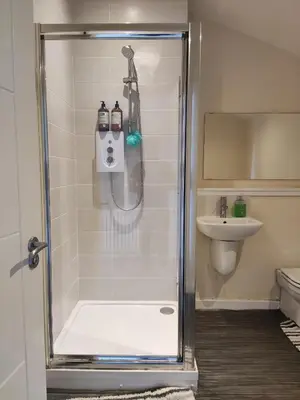 a shower stall in a bathroom with a sink at My room in Edinburgh
