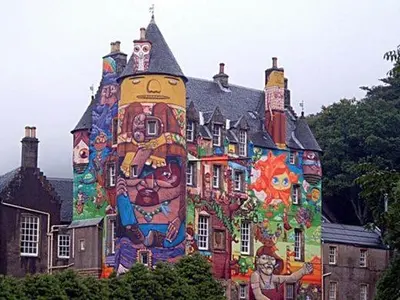 a building with a large painting on the side of it at Spacious stylish centraly located flat near beach in Largs