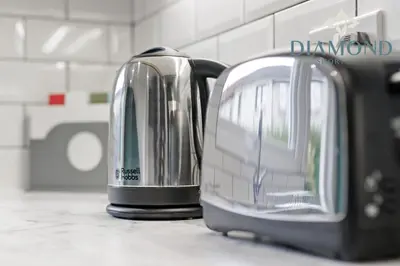 two toasters sitting next to each other on a counter at Grangemouth, 3 Bed House, Free Parking, Business or Leisure in Grangemouth