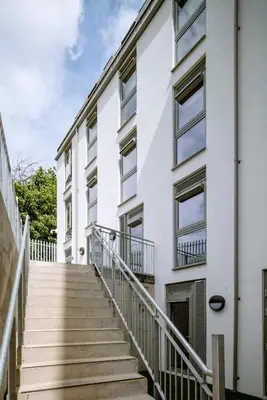 a stairway leading up to a white building at Modern Studio Apartments at Murieston Crescent in Edinburgh in Edinburgh