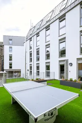 a large white ping pong table in front of a building at Modern Studio Apartments at Murieston Crescent in Edinburgh in Edinburgh