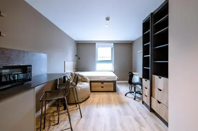 a bedroom with a bed and a desk in a room at Modern Studio Apartments at Murieston Crescent in Edinburgh in Edinburgh