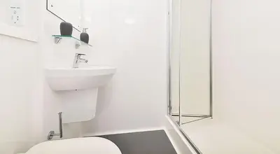 a white bathroom with a toilet and a sink at HFS The Mill House Edinburgh in Edinburgh