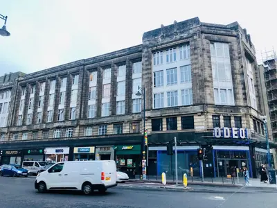 a white van driving down a street in front of a building at Apartment with City Views - Sleeps 3 in Edinburgh