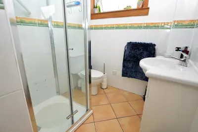 a bathroom with a shower and a toilet and a sink at Brookfield in Sandbank