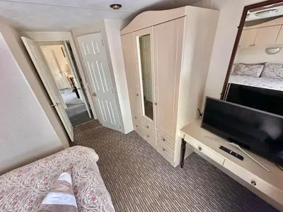 a bedroom with a tv and a bed and a mirror at 2 Bedroom Caravan Located in Uddingston, Glasgow at Maryville Caravan Site in Uddingston