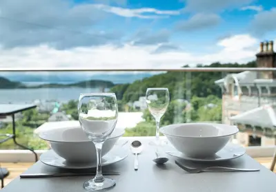 a table with two glasses and a bowl and a bowl at Benvoulin Bothy - luxury pod with stunning views in Oban