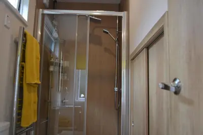 a shower with a glass door in a bathroom at Benvoulin Bothy - luxury pod with stunning views in Oban