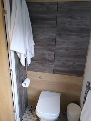 a bathroom with a white toilet and a shower at The Cuddies in Balloch