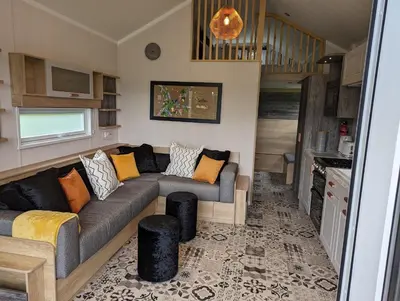 a living room with a couch in a tiny house at The Cuddies in Balloch