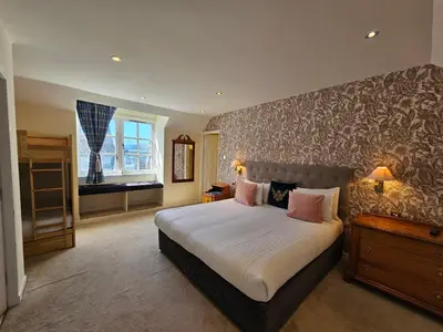 a bedroom with a large bed and a window at Taychreggan, Signature Collection by Eight Continents in Oban