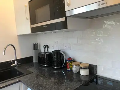 a kitchen with a sink and a counter top at Cosy one bedroom flat in city center in Edinburgh