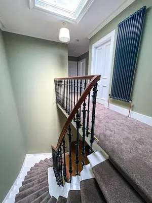 a spiral staircase in a home with a window at Remarkable 5BR Townhouse with Garden, Sleeps 12 in Edinburgh