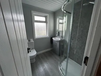a bathroom with a toilet and a glass shower at Viewlands house in Auchterarder