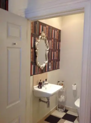 a bathroom with a sink and a mirror at A Room in the City - West in Edinburgh