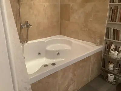 a white bath tub in a bathroom at A Room in the City - West in Edinburgh