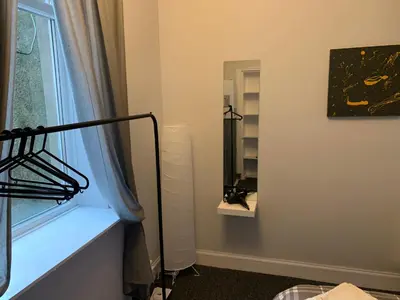 a room with a window and a mirror at Nelson st (ANNAN) in Largs