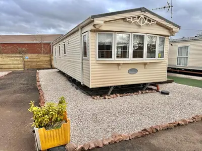 a tiny house sitting on top of a pile of gravel at Willerby Granada 2-Bedroom Located in Uddingston, Glasgow at Maryville Caravan Site in Uddingston