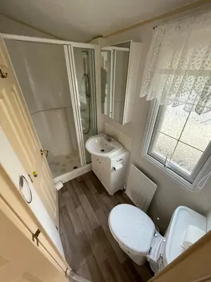 a small bathroom with a toilet and a sink at Willerby Granada 2-Bedroom Located in Uddingston, Glasgow at Maryville Caravan Site in Uddingston