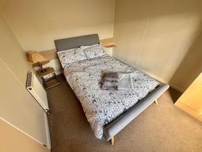 an overhead view of a bed in a small room at Two Bedroom Willerby Caravan Located in Uddingston, Glasgow at Maryville Caravan Site in Uddingston