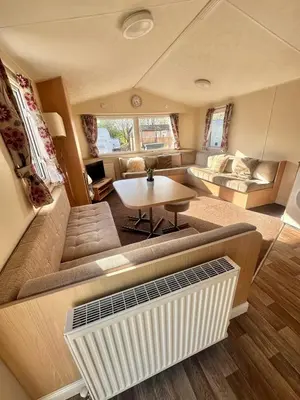 a living room with a couch and a table at Two Bedroom Willerby Caravan Located in Uddingston, Glasgow at Maryville Caravan Site in Uddingston