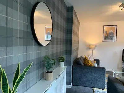 a living room with a mirror and a couch at Modern 2 bedroom flat with free parking in Cambuslang, Glasgow in Glasgow