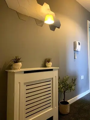 a room with a ceiling fan and plants on a wall at Modern 2 bedroom flat with free parking in Cambuslang, Glasgow in Glasgow