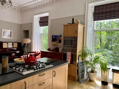 a kitchen with a stove with a pot on it at Beautiful Double Room in Idyllic West End Townhouse in Glasgow