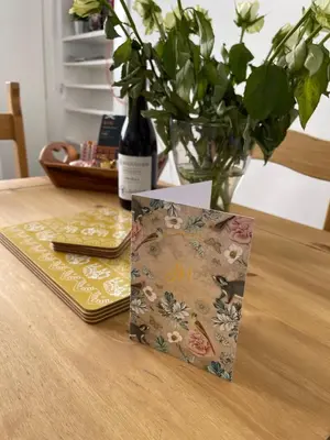 a book sitting on a table with a vase of flowers at A Shore Stay in Gourock