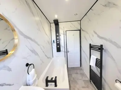 a bathroom with a tub and a sink and a mirror at 4 Bedrooms Apartment By Sensational Stay Short Lets & Serviced Accommodation in Edinburgh