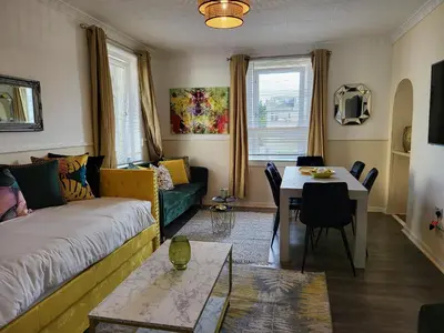 a living room with a couch and a table at 4 Bedrooms Apartment By Sensational Stay Short Lets & Serviced Accommodation in Edinburgh