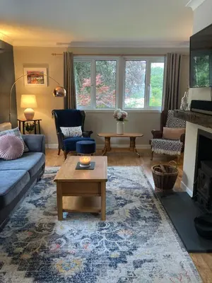 a living room with a couch and a table at Cedar Lodge in Oban