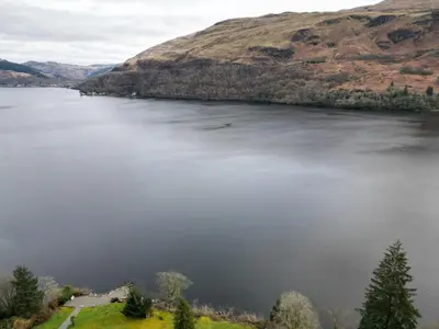 a view of a body of water with a mountain at WATERSIDE 3 BED COTTAGE, HOT TUB, SAUNA, PVT BEACH in Arrochar