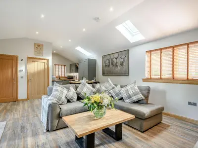 a living room with a couch and a table at Appletree Lodge in Ayr