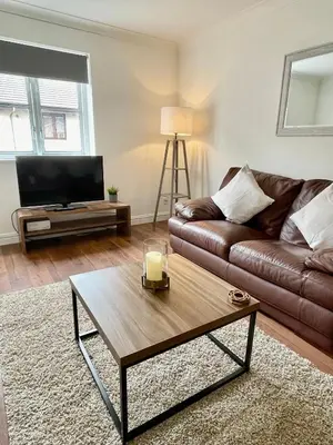 a living room with a couch and a coffee table at Modern 2 bedroom apartment near Glasgow Airport in Paisley