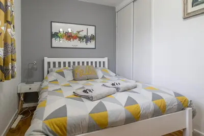 a bedroom with a bed with towels on it at 1 bed apartment central Hamilton free wifi with great transport links to Glasgow in Hamilton