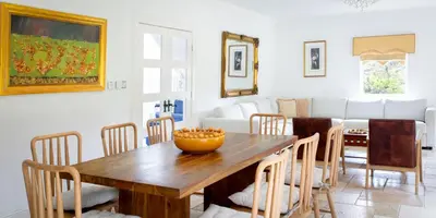 a dining room with a wooden table and chairs at Stunning 4-Bedroom Country House with Hot Tub & Sauna near Loch Lomond in Glasgow