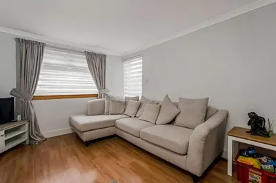 a living room with a couch and a tv at Centrally Situated 1 Bedroom House in Cumbernauld in Cumbernauld