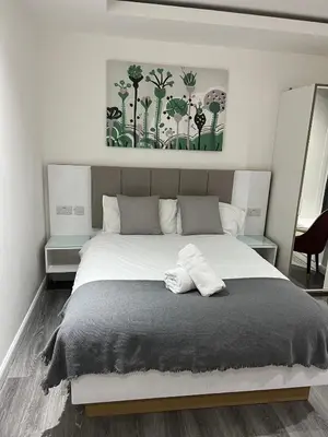 a bedroom with a large white bed in a room at Crosskeys Edinburgh in Edinburgh