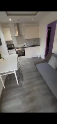 a living room with a couch and a table in it at Crosskeys Edinburgh in Edinburgh