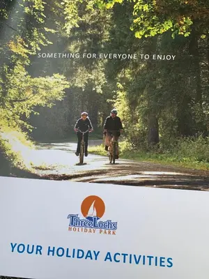 two people riding bikes down a dirt road at HV66 - FREE WIFI-3 Bedrooms Indoor Pool Loch Views Fishing Golf Riding Shooting Water Sports 15 Mins Drive To Beaches PASSES NOT INCLUDED Most Activities Will Not Be Available Out Of Season Please Check Before Booking in Newton Stewart